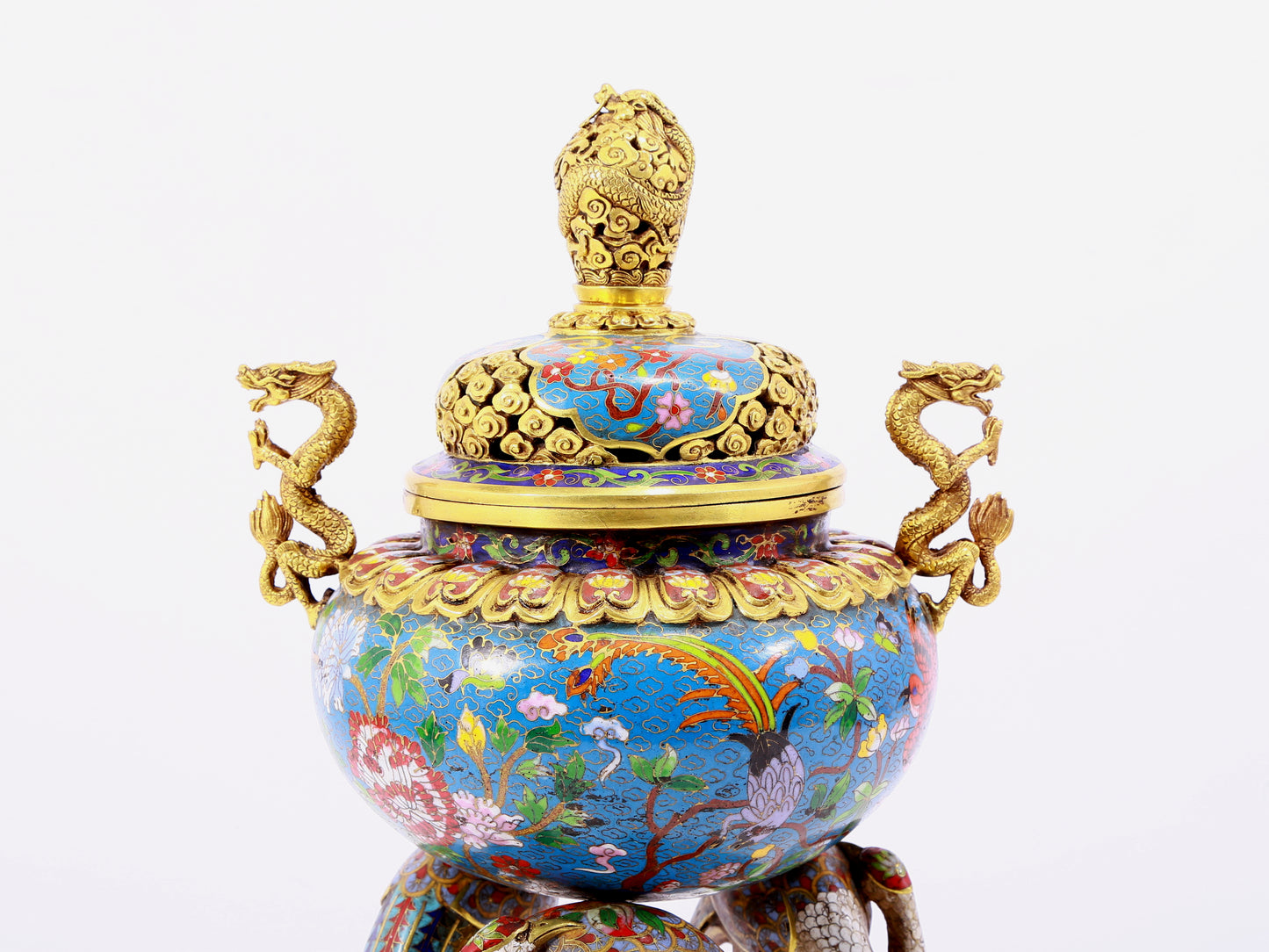 A cloisonné flower and bird pattern two-eared three-legged incense burner with lid