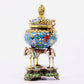 A cloisonné flower and bird pattern two-eared three-legged incense burner with lid