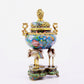 A cloisonné flower and bird pattern two-eared three-legged incense burner with lid