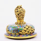 A cloisonné flower and bird pattern two-eared three-legged incense burner with lid