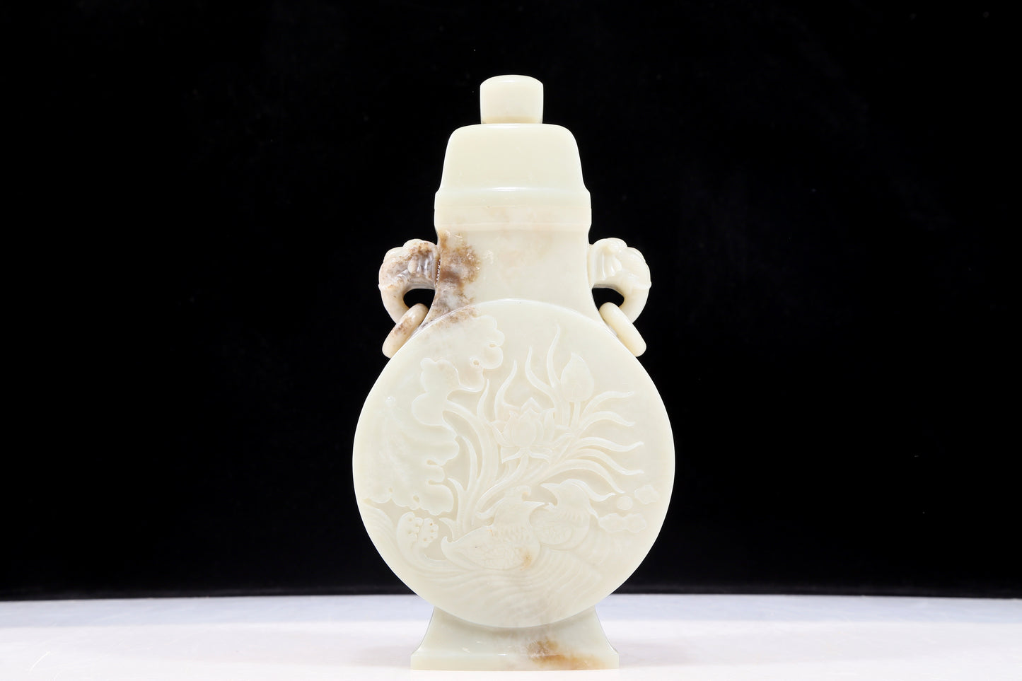 An exquisite white jade elephant ear vase with flower and bird patterns and lid