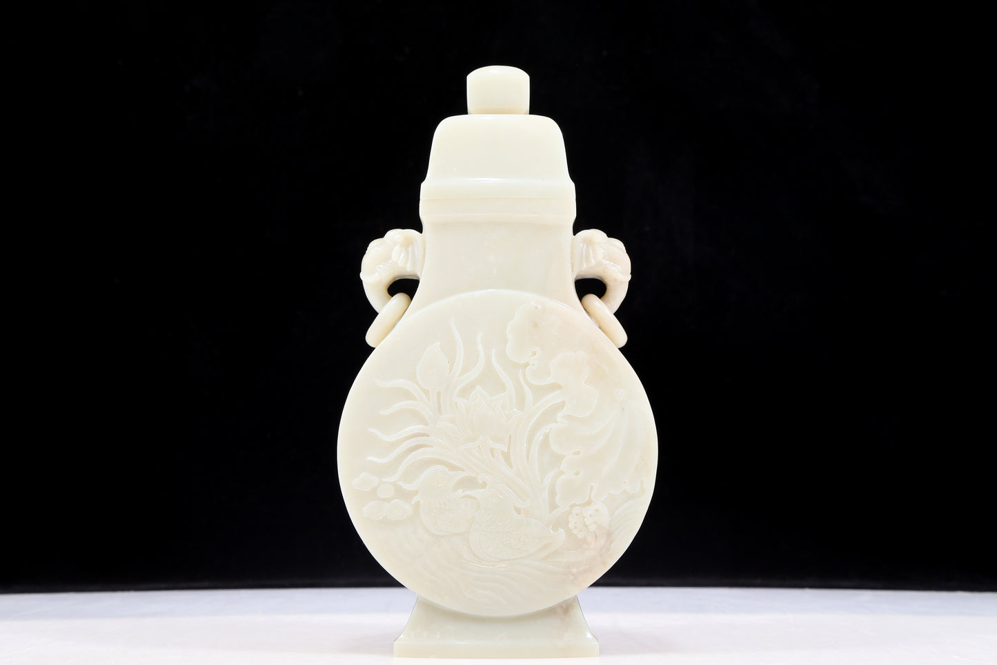 An exquisite white jade elephant ear vase with flower and bird patterns and lid