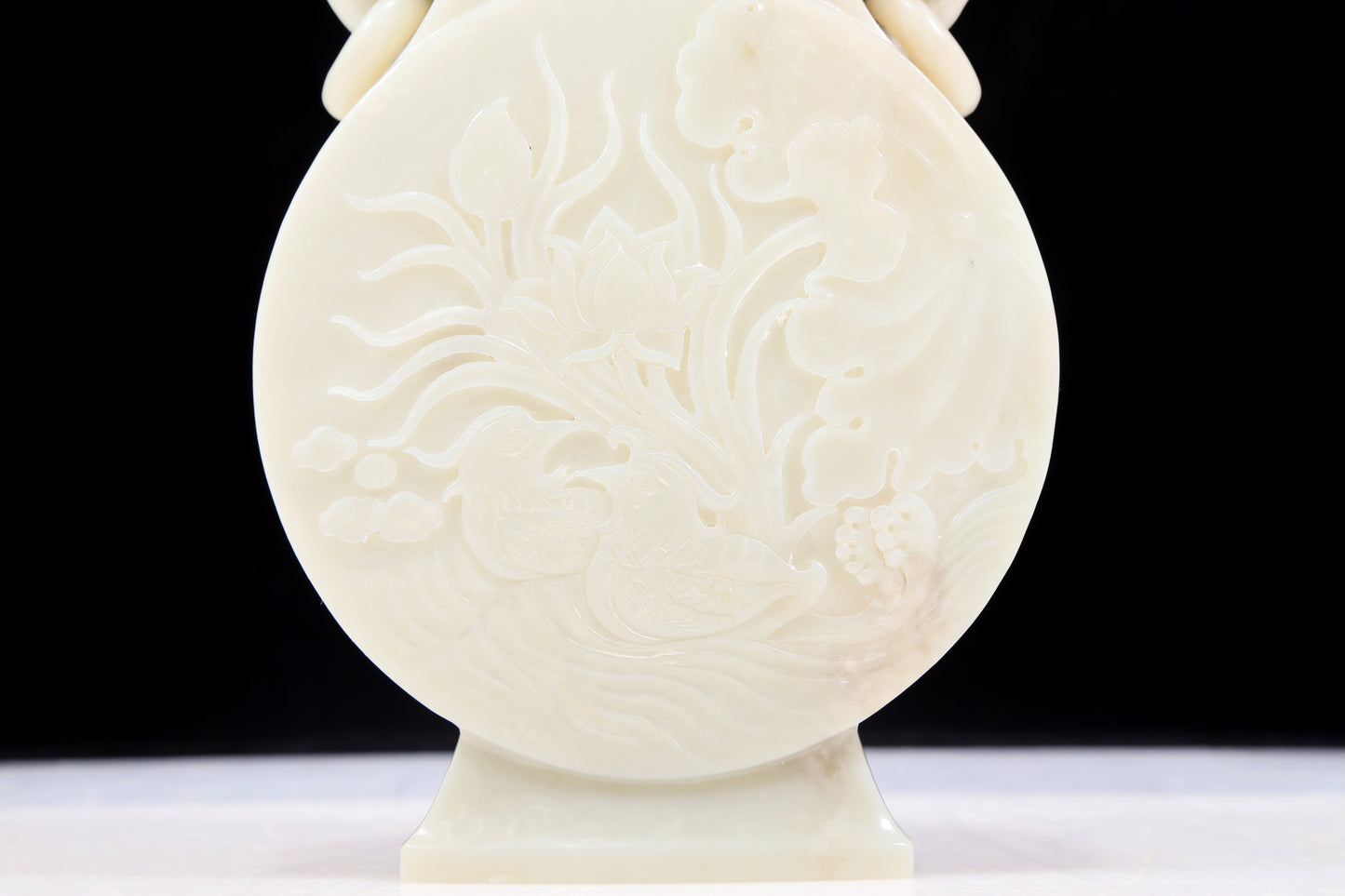 An exquisite white jade elephant ear vase with flower and bird patterns and lid