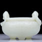 A Precious White Jade 'Dragon' Tripod Censer. Carved with archaistic motifs. Chinese Qing Dynasty. Size:11cmx7.5cm. Weight:400g     清代 白玉龙纹双耳三足炉