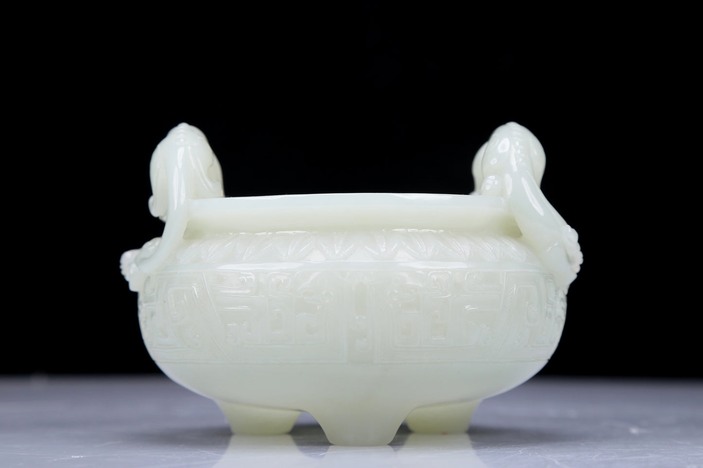 A Precious White Jade 'Dragon' Tripod Censer. Carved with archaistic motifs. Chinese Qing Dynasty. Size:11cmx7.5cm. Weight:400g     清代 白玉龙纹双耳三足炉