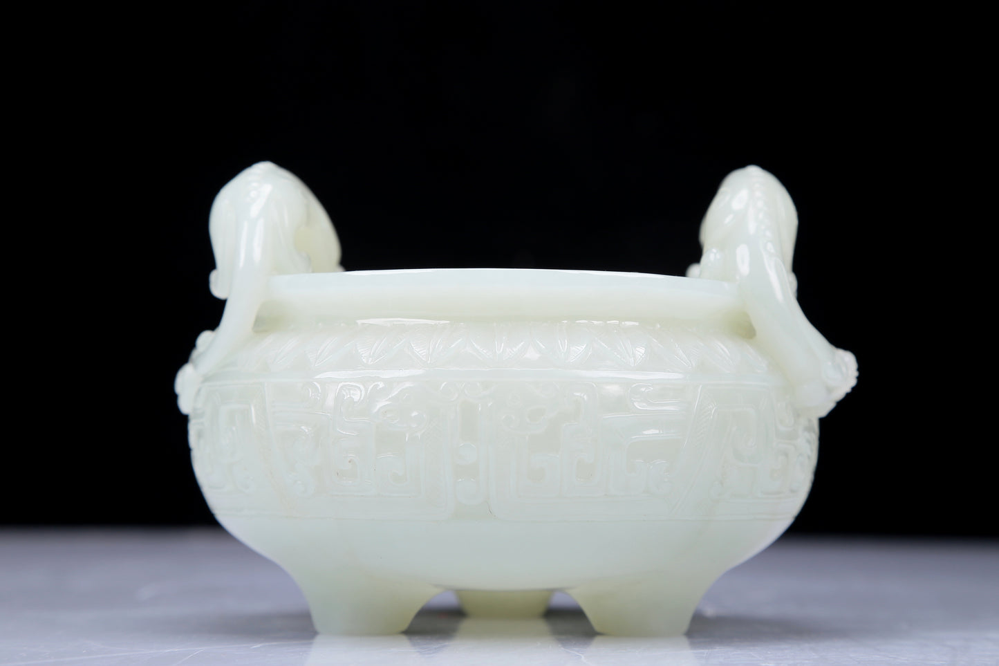 A Precious White Jade 'Dragon' Tripod Censer. Carved with archaistic motifs. Chinese Qing Dynasty. Size:11cmx7.5cm. Weight:400g     清代 白玉龙纹双耳三足炉