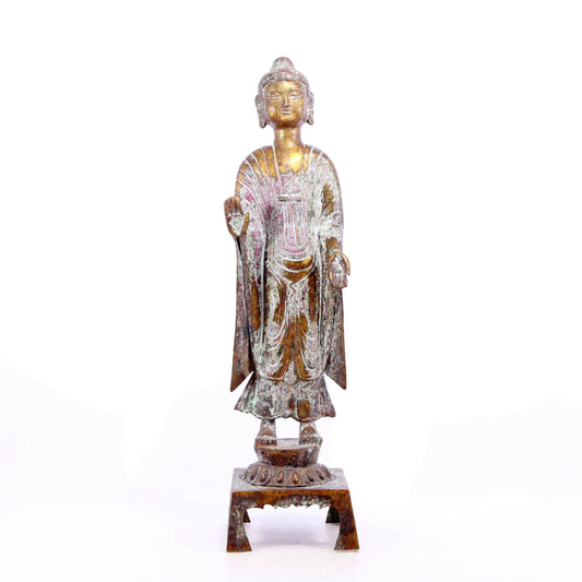 A serene gilt bronze statue of Gautama Buddha