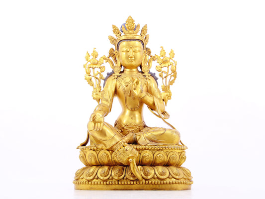 A solemn gilt bronze statue of green Tara