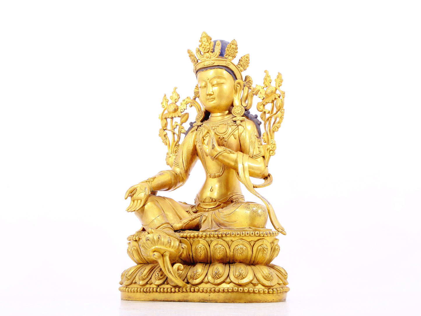 A solemn gilt bronze statue of green Tara