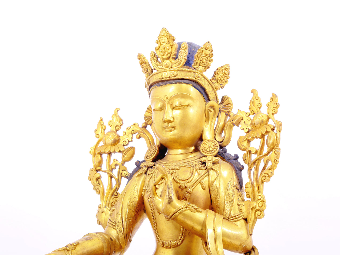 A solemn gilt bronze statue of green Tara