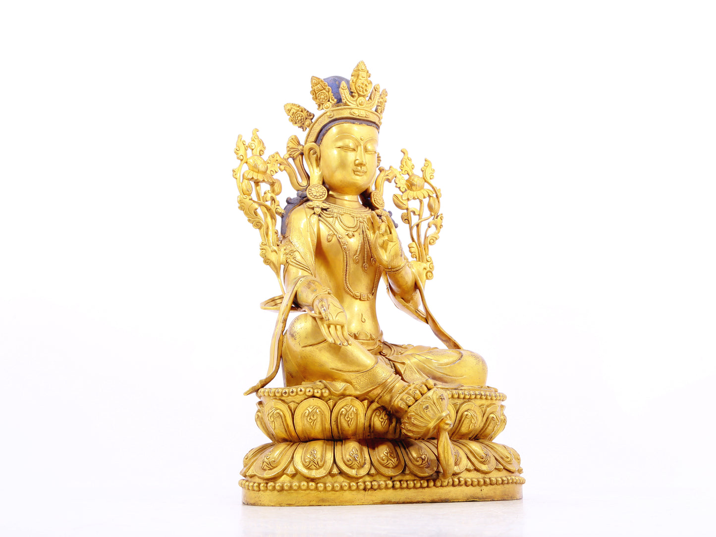 A solemn gilt bronze statue of green Tara