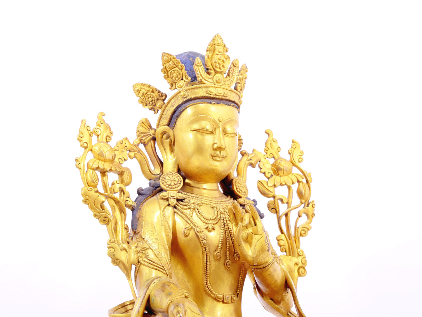 A solemn gilt bronze statue of green Tara