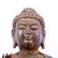 A solemn gilt bronze statue of Gautama Buddha