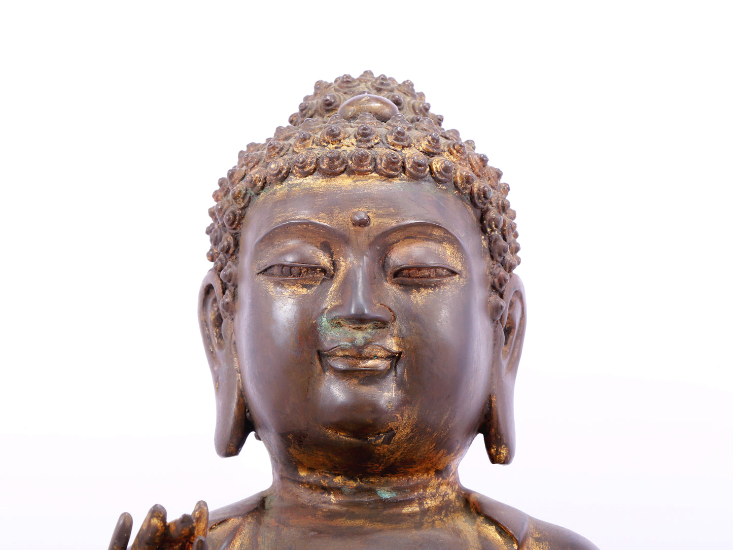 A solemn gilt bronze statue of Gautama Buddha