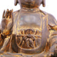 A solemn gilt bronze statue of Gautama Buddha