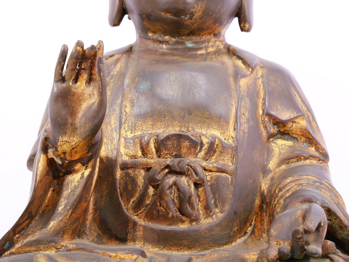 A solemn gilt bronze statue of Gautama Buddha