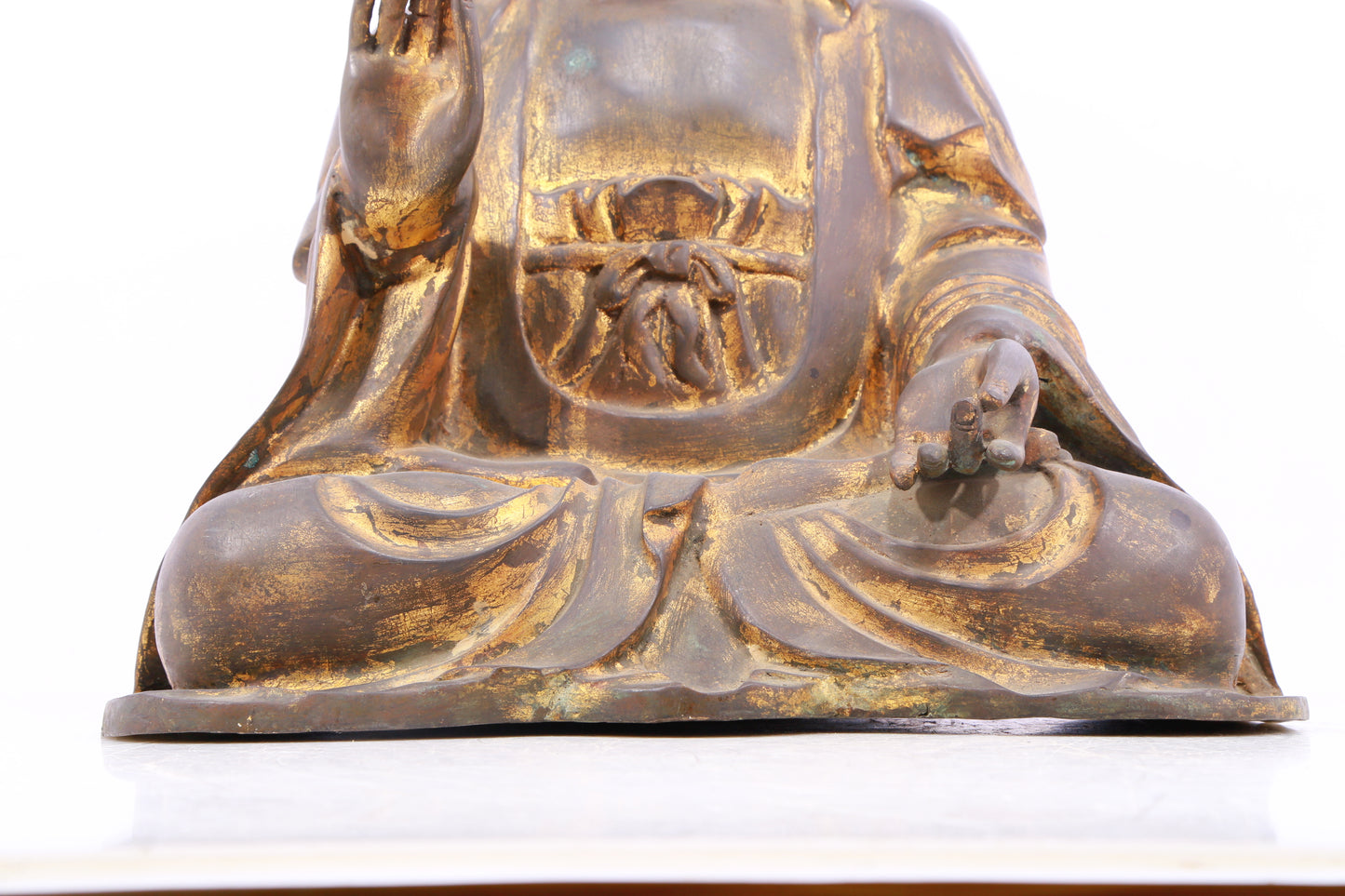 A solemn gilt bronze statue of Gautama Buddha