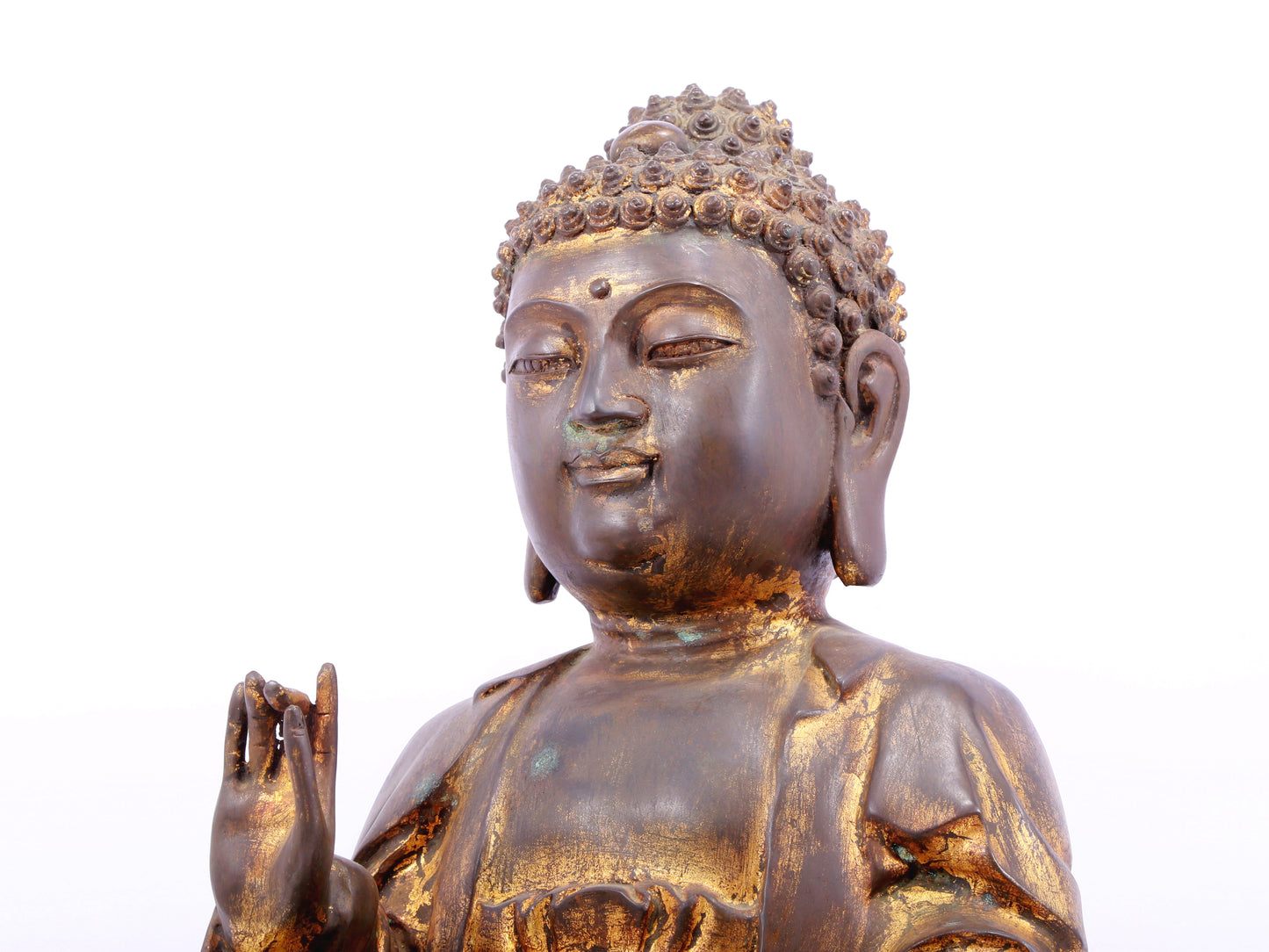 A solemn gilt bronze statue of Gautama Buddha