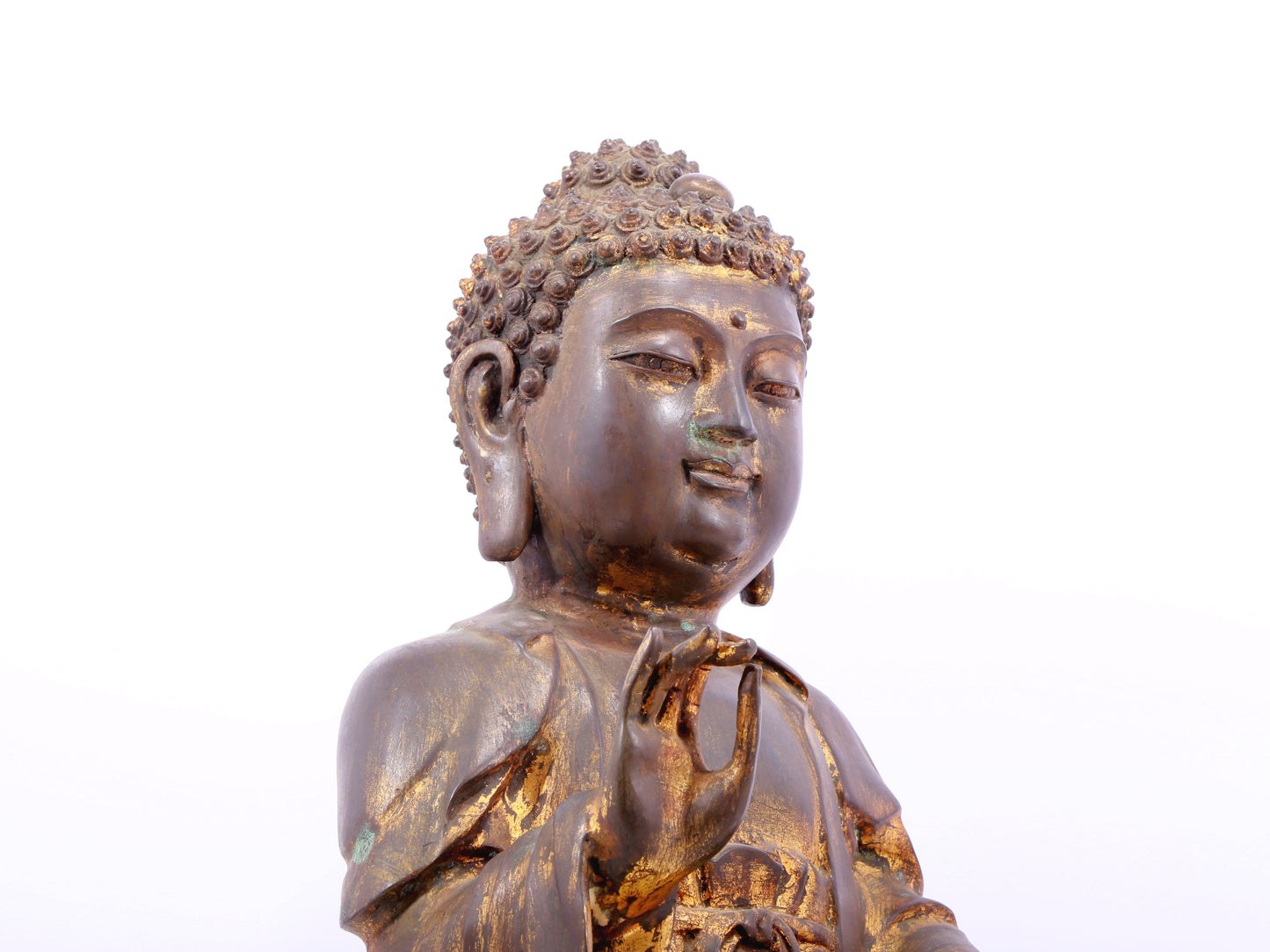 A solemn gilt bronze statue of Gautama Buddha