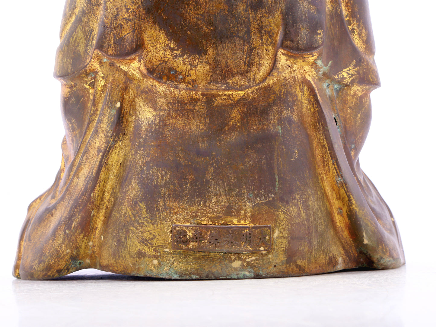 A solemn gilt bronze statue of Gautama Buddha