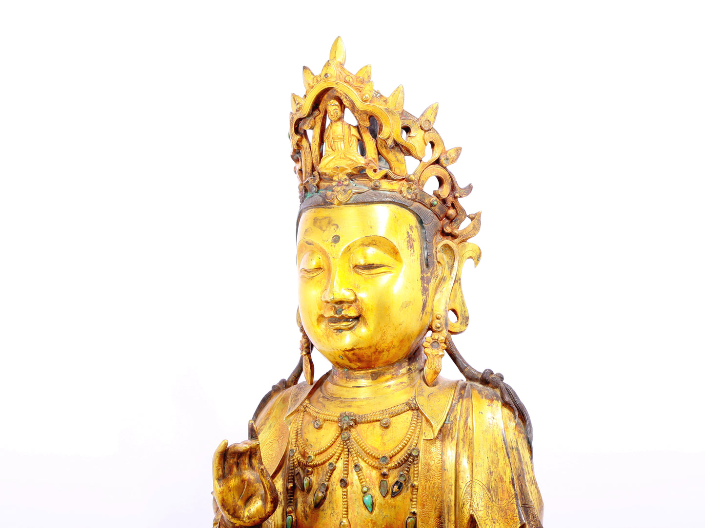 A solemn gilt bronze statue of Guanyin