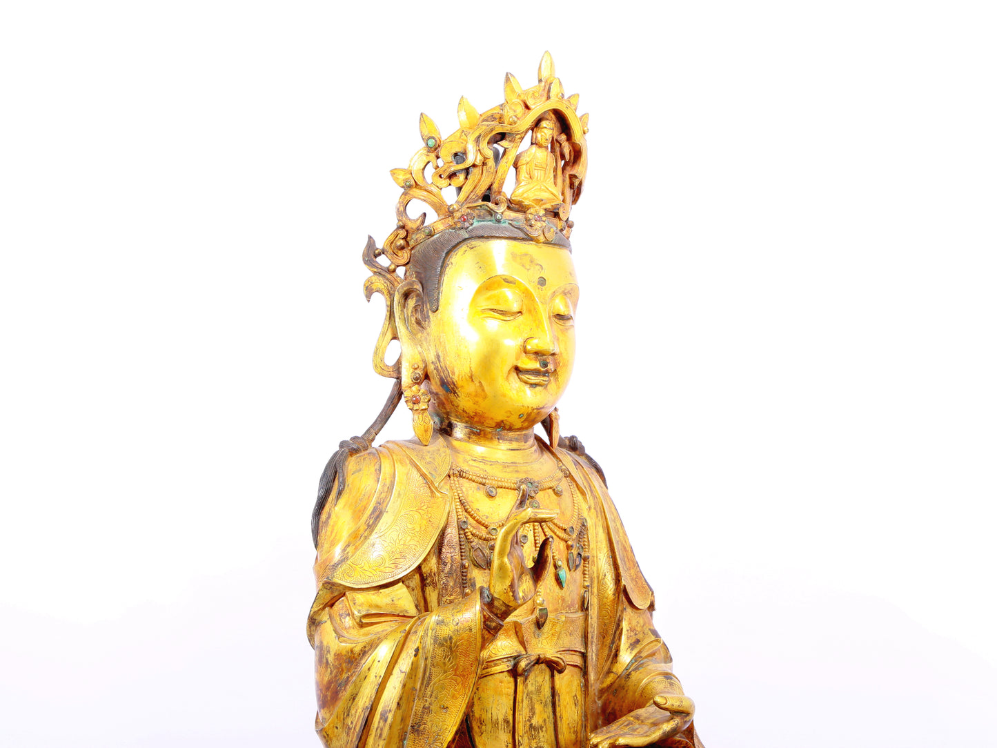 A solemn gilt bronze statue of Guanyin