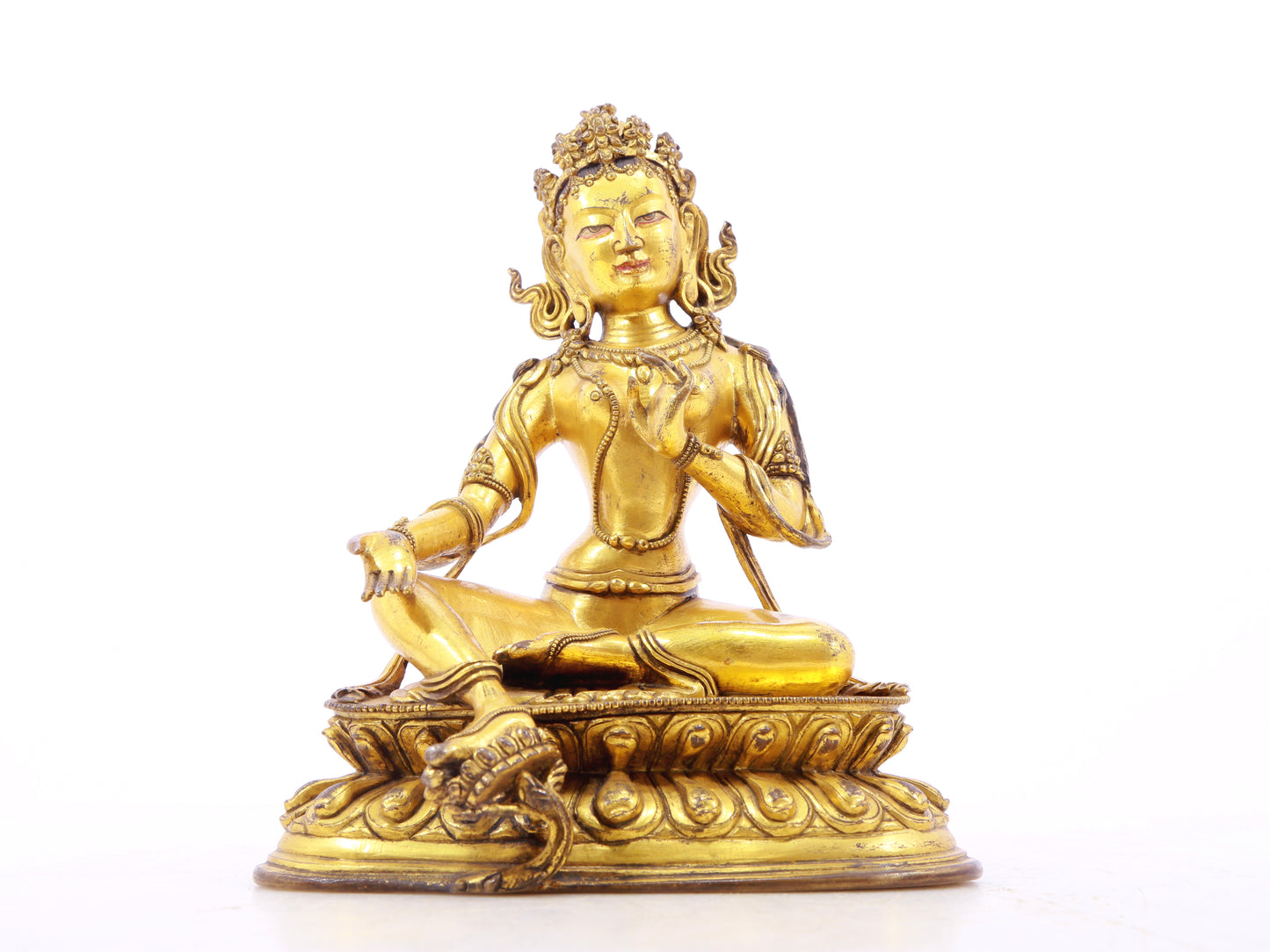 A serene gilt bronze statue of green Tara