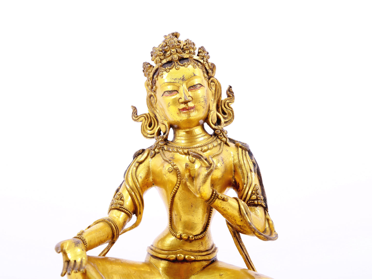 A serene gilt bronze statue of green Tara