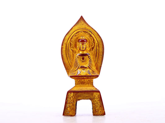 A serene gilt bronze statue of Gautama Buddha