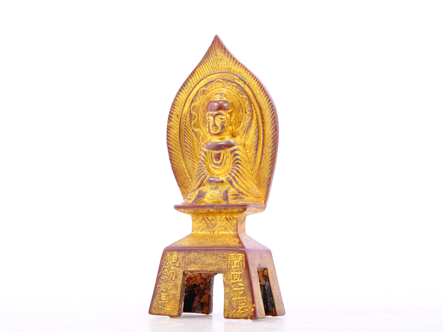 A serene gilt bronze statue of Gautama Buddha