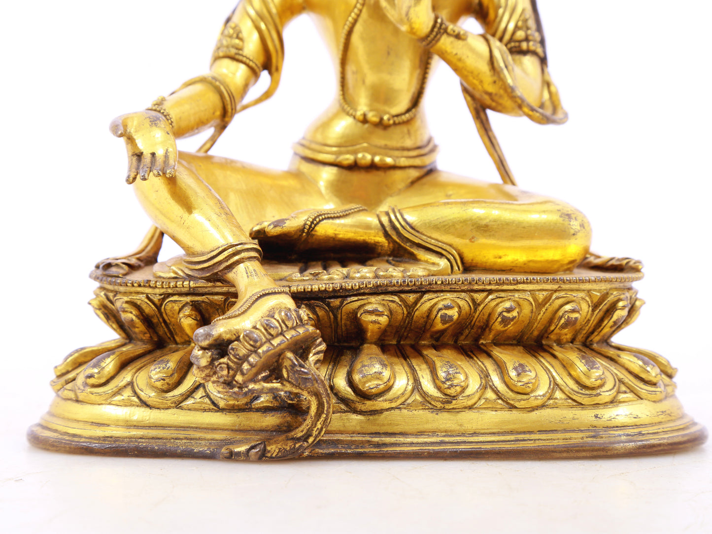 A serene gilt bronze statue of green Tara