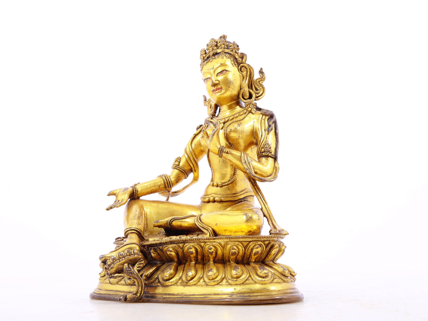 A serene gilt bronze statue of green Tara