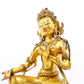 A serene gilt bronze statue of green Tara