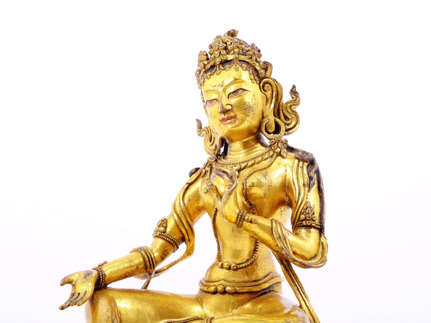 A serene gilt bronze statue of green Tara