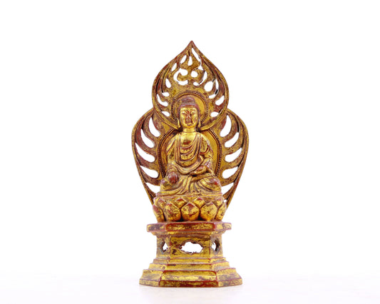 A serene gilt bronze statue of Gautama Buddha