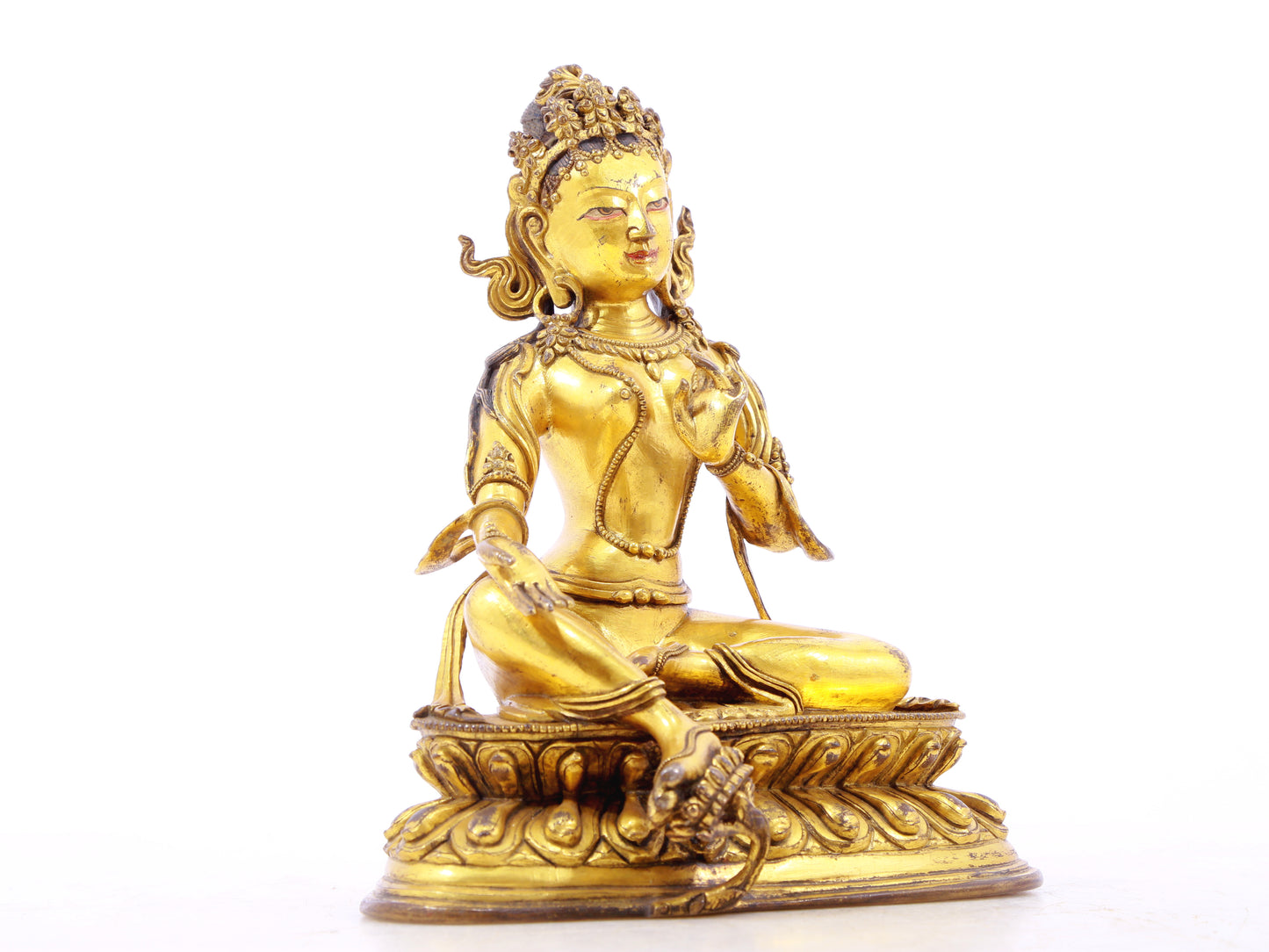 A serene gilt bronze statue of green Tara