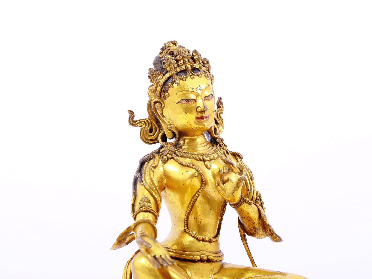 A serene gilt bronze statue of green Tara