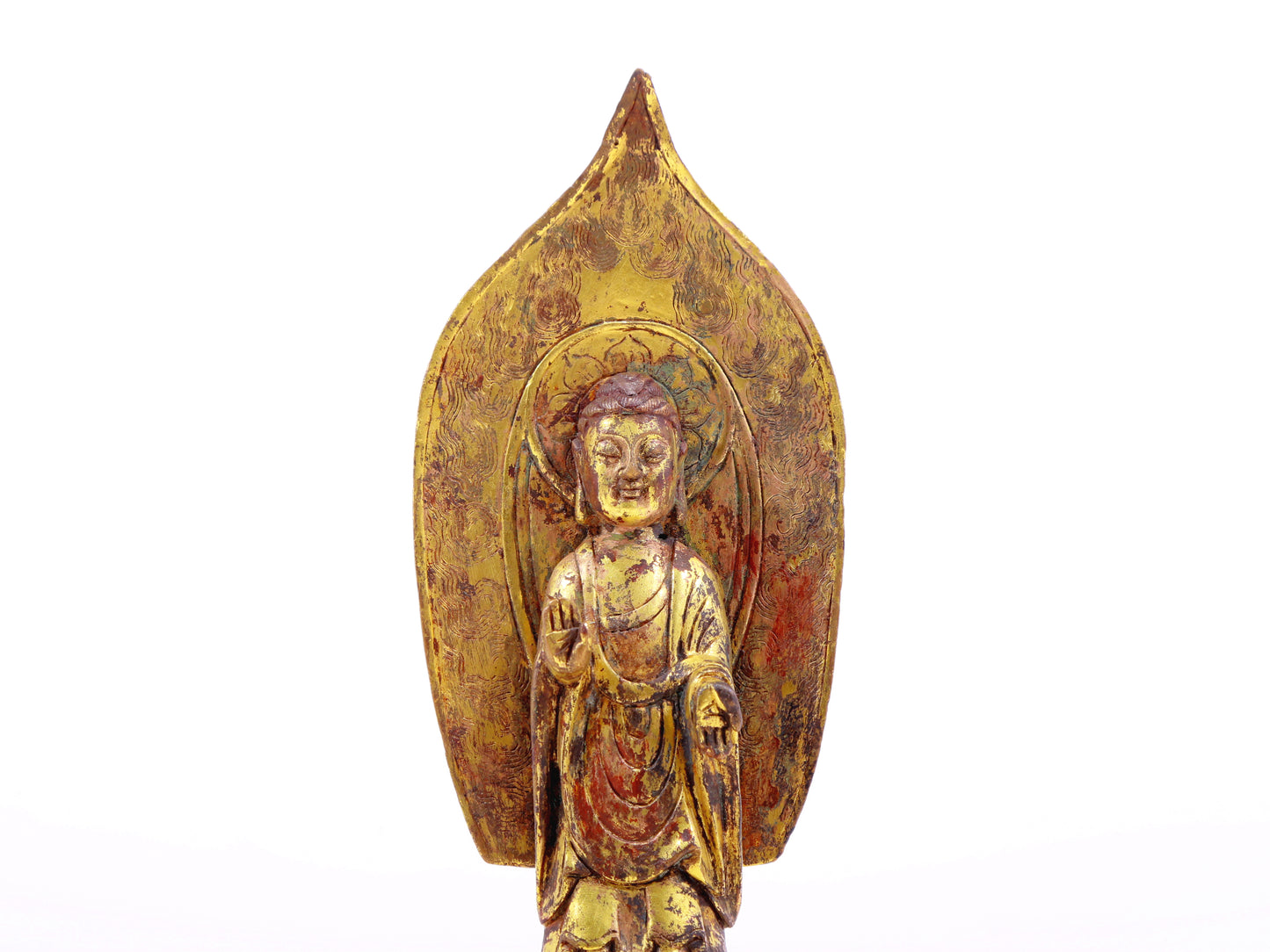 A serene gilt bronze statue of Gautama Buddha