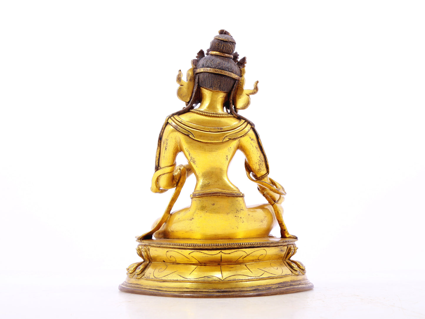 A serene gilt bronze statue of green Tara