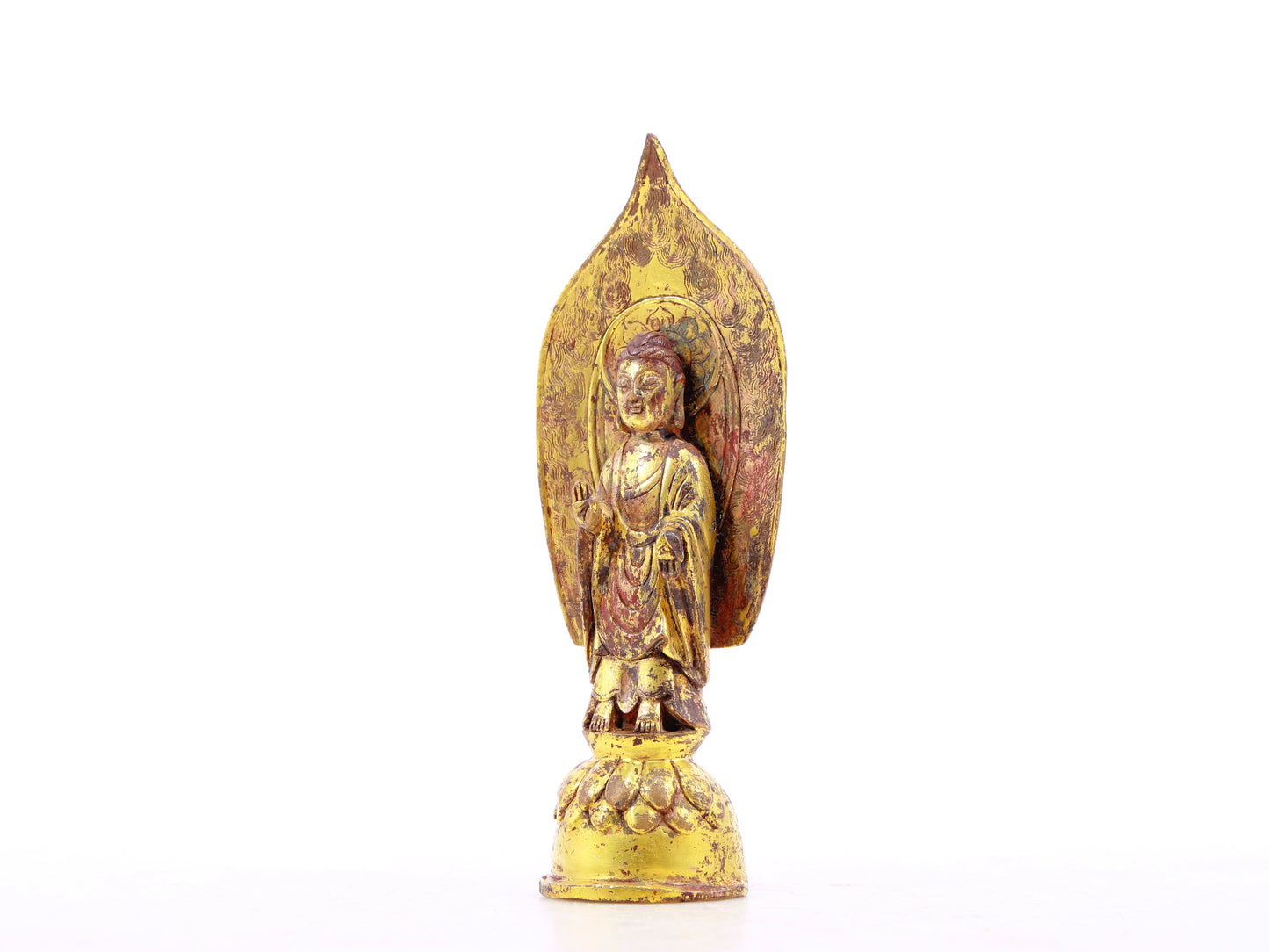 A serene gilt bronze statue of Gautama Buddha