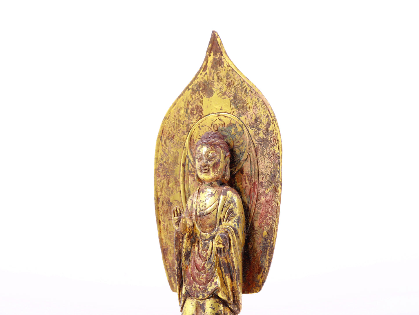 A serene gilt bronze statue of Gautama Buddha