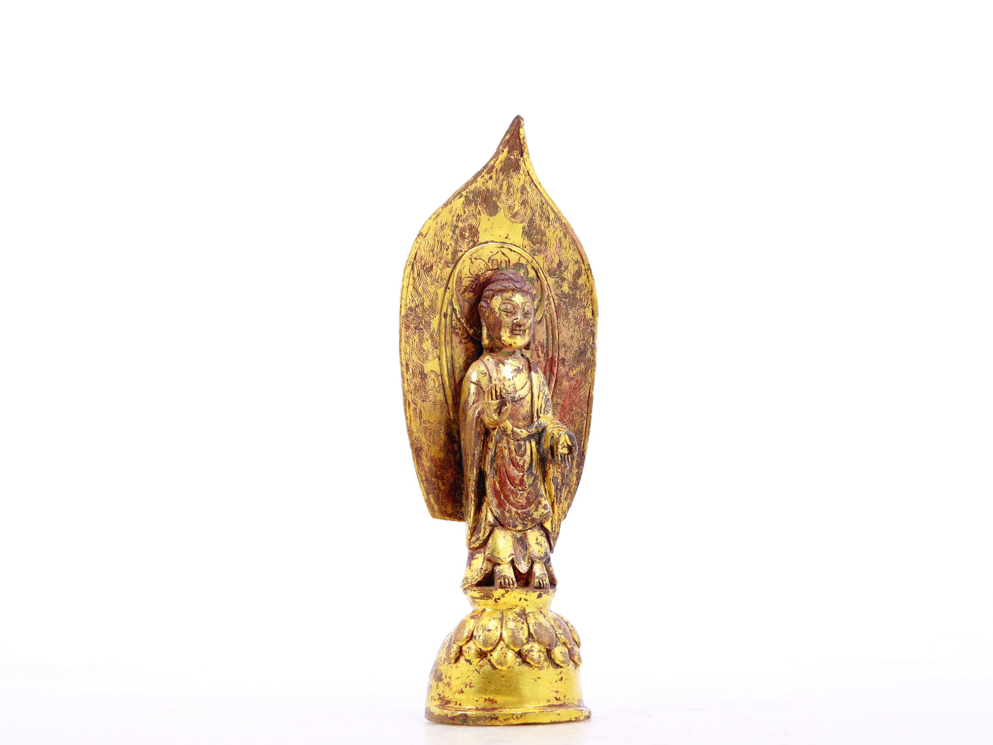 A serene gilt bronze statue of Gautama Buddha