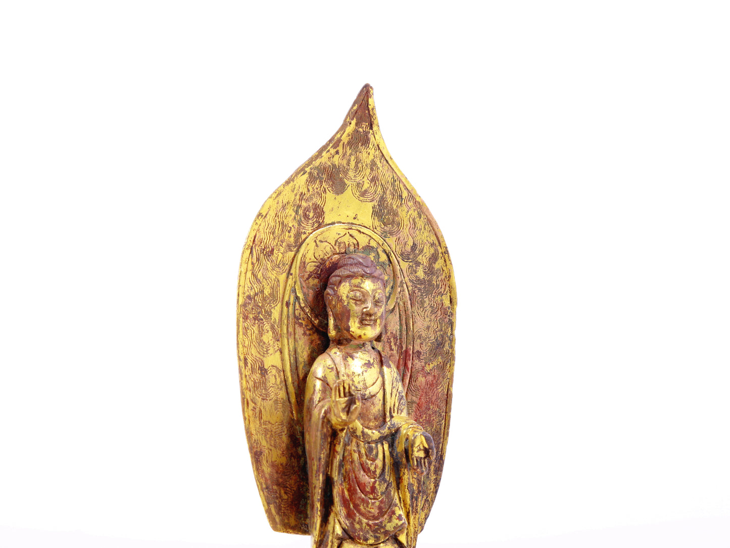 A serene gilt bronze statue of Gautama Buddha