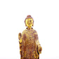 A serene gilt bronze statue of Gautama Buddha