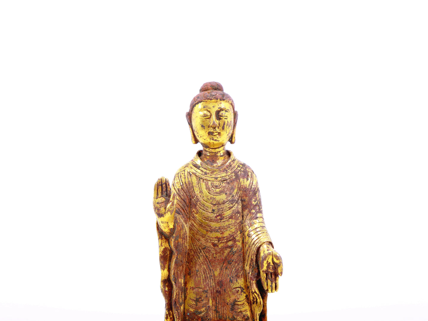 A serene gilt bronze statue of Gautama Buddha