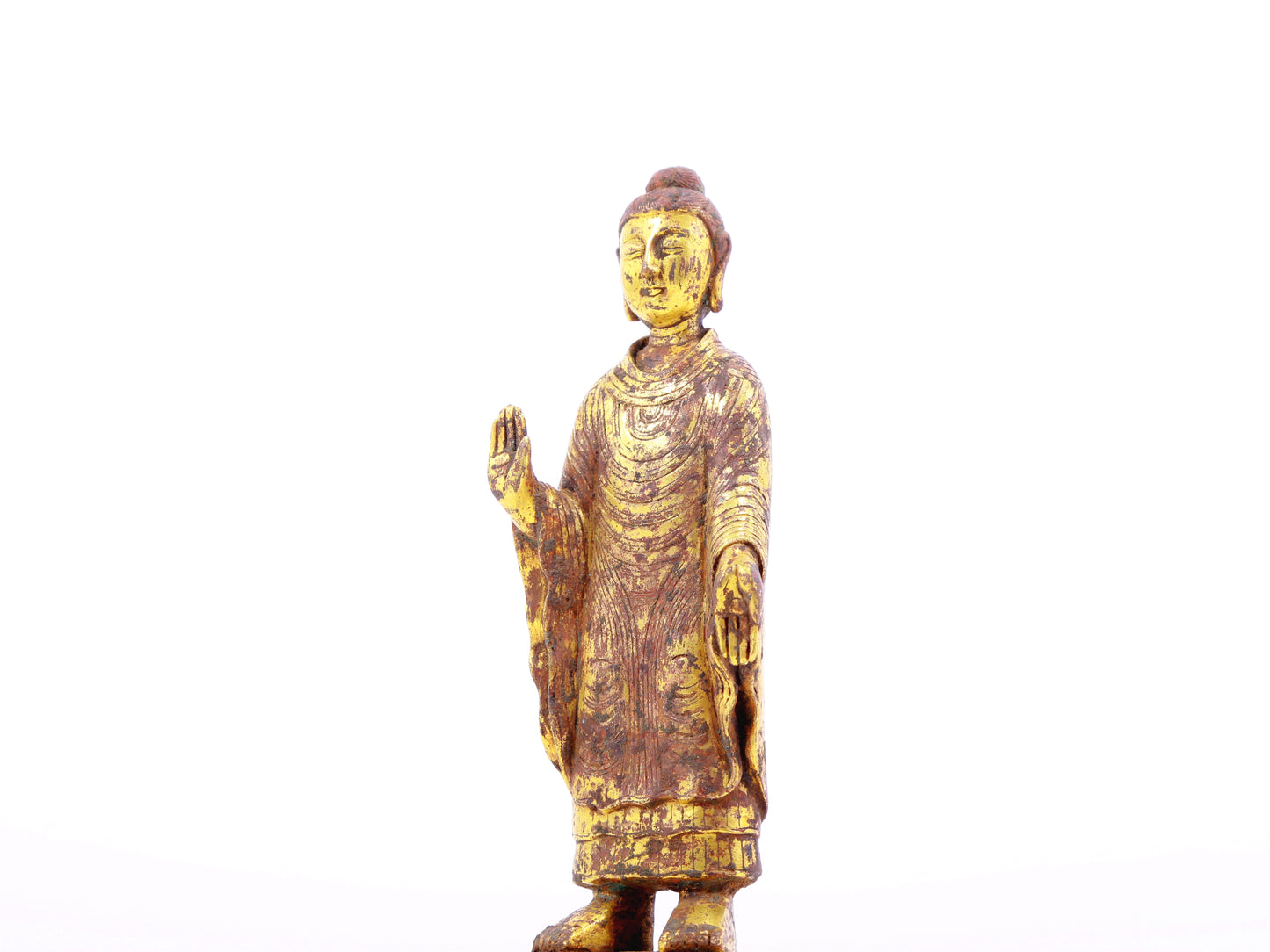 A serene gilt bronze statue of Gautama Buddha