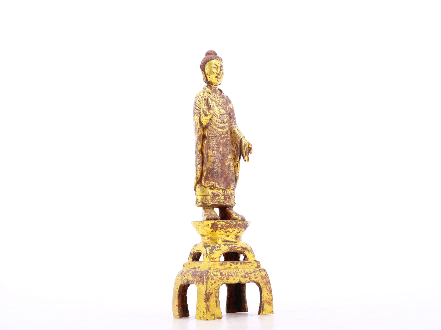 A serene gilt bronze statue of Gautama Buddha