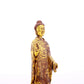 A serene gilt bronze statue of Gautama Buddha