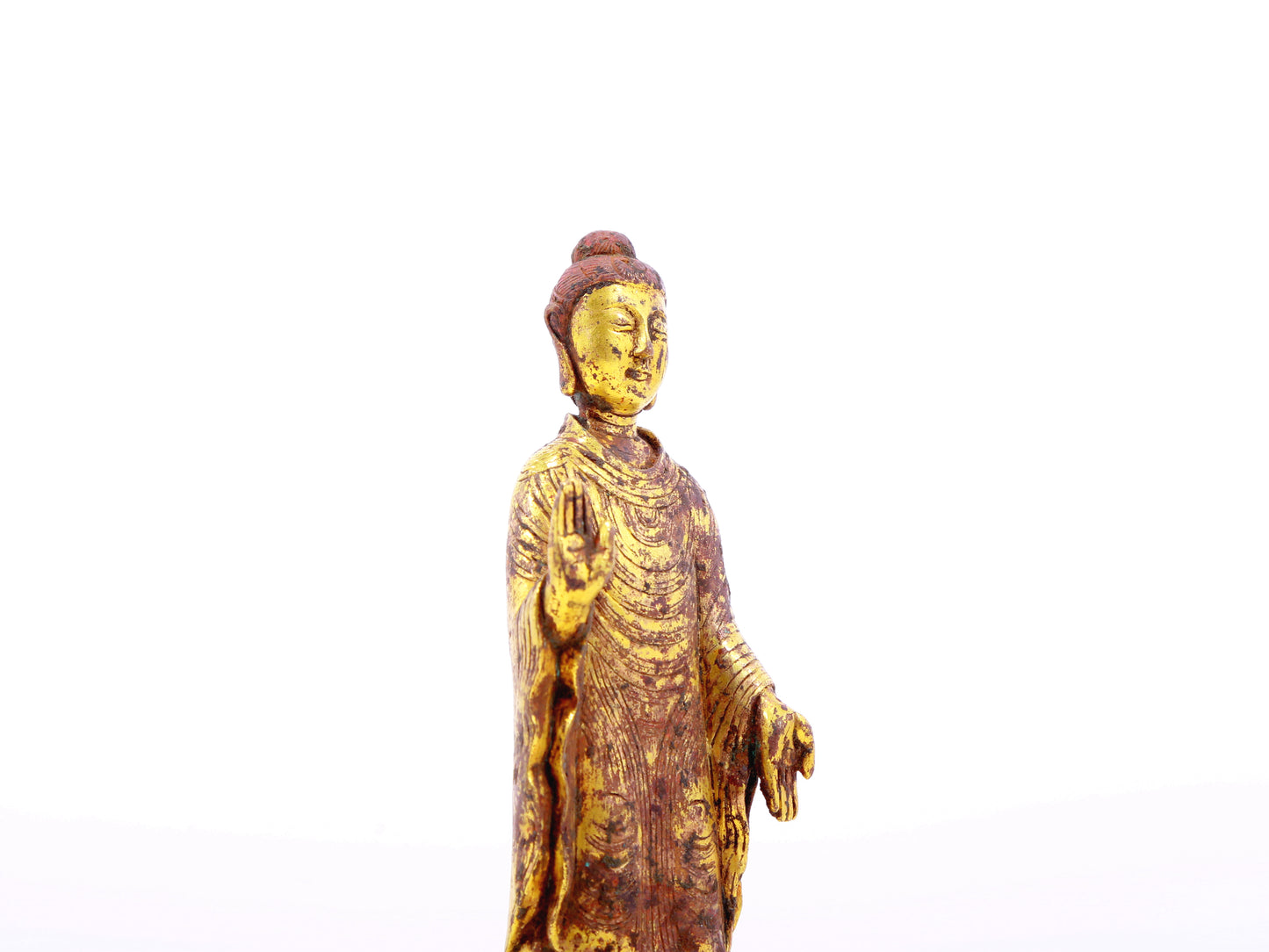 A serene gilt bronze statue of Gautama Buddha