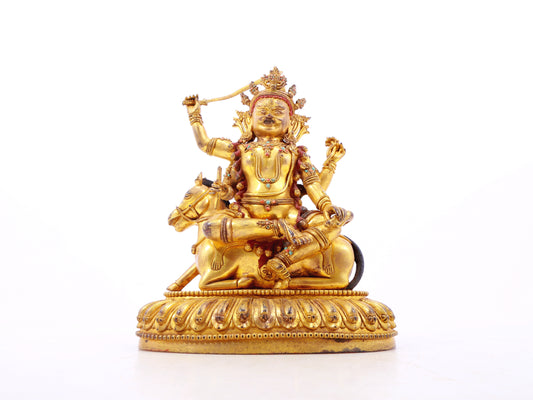 A serene gilt bronze statue of the Heavenly King inlaid with precious stones